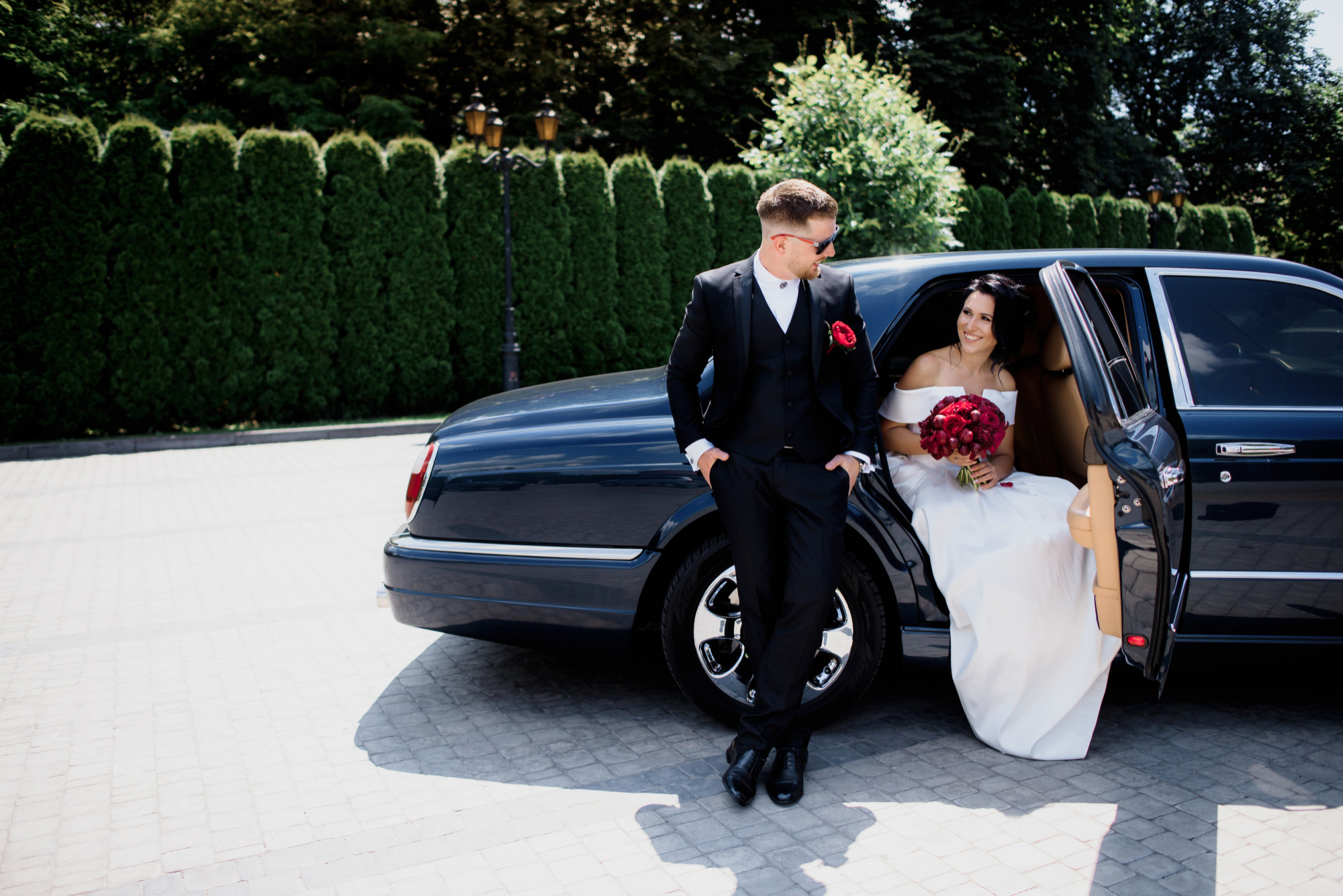 A couple getting out of a black limousine for their Las Vegas Wedding at Lucky Little Chapel.